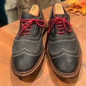 Allen Edmonds Navy Wing Tips with white stitching and red laces